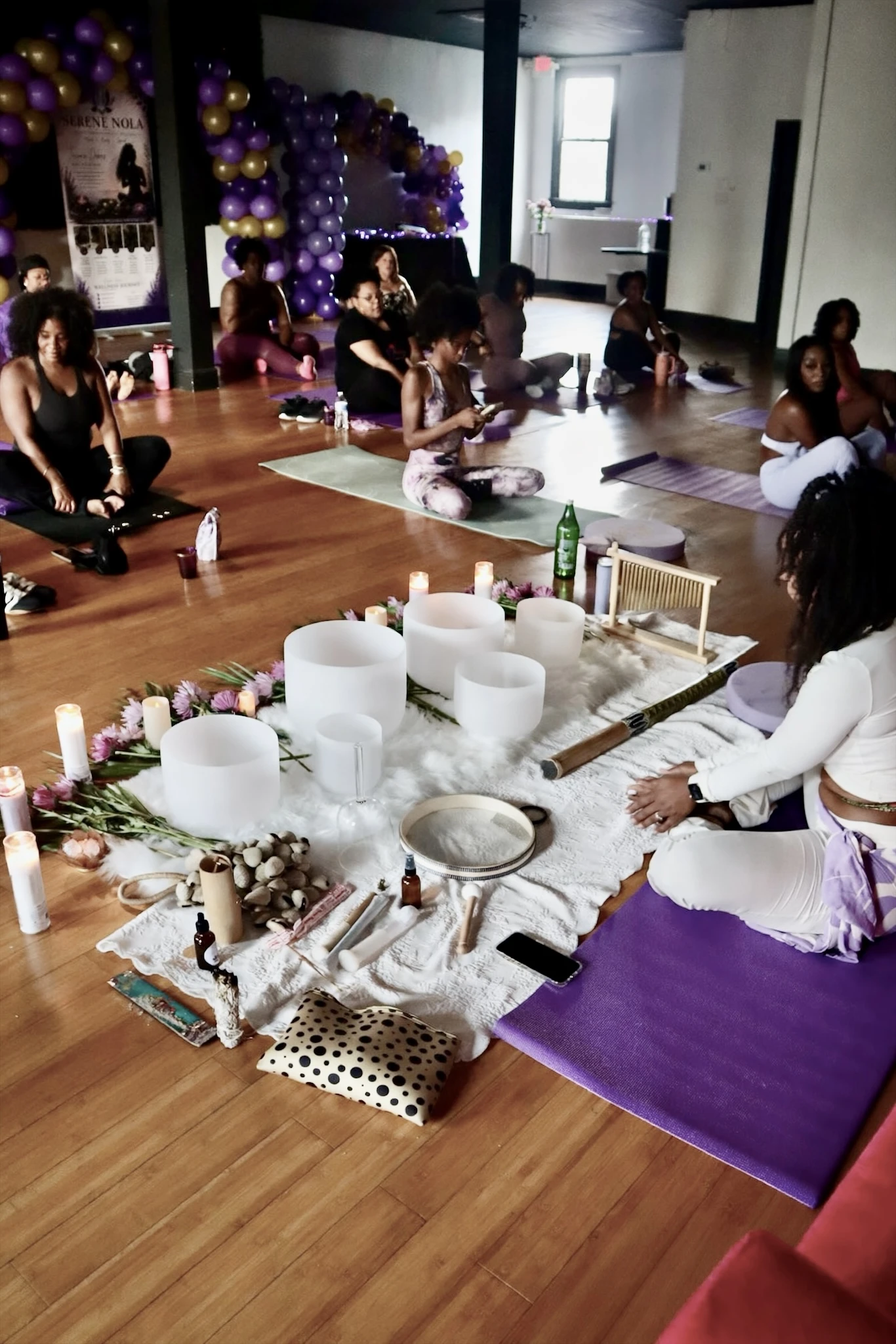 Tieara leading a group sound bath with crystal singing bowls at a Serene NOLA wellness experience