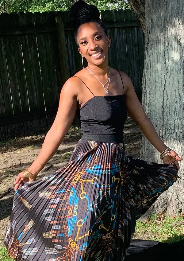 Tieara Dokes smiling outdoors in a garden