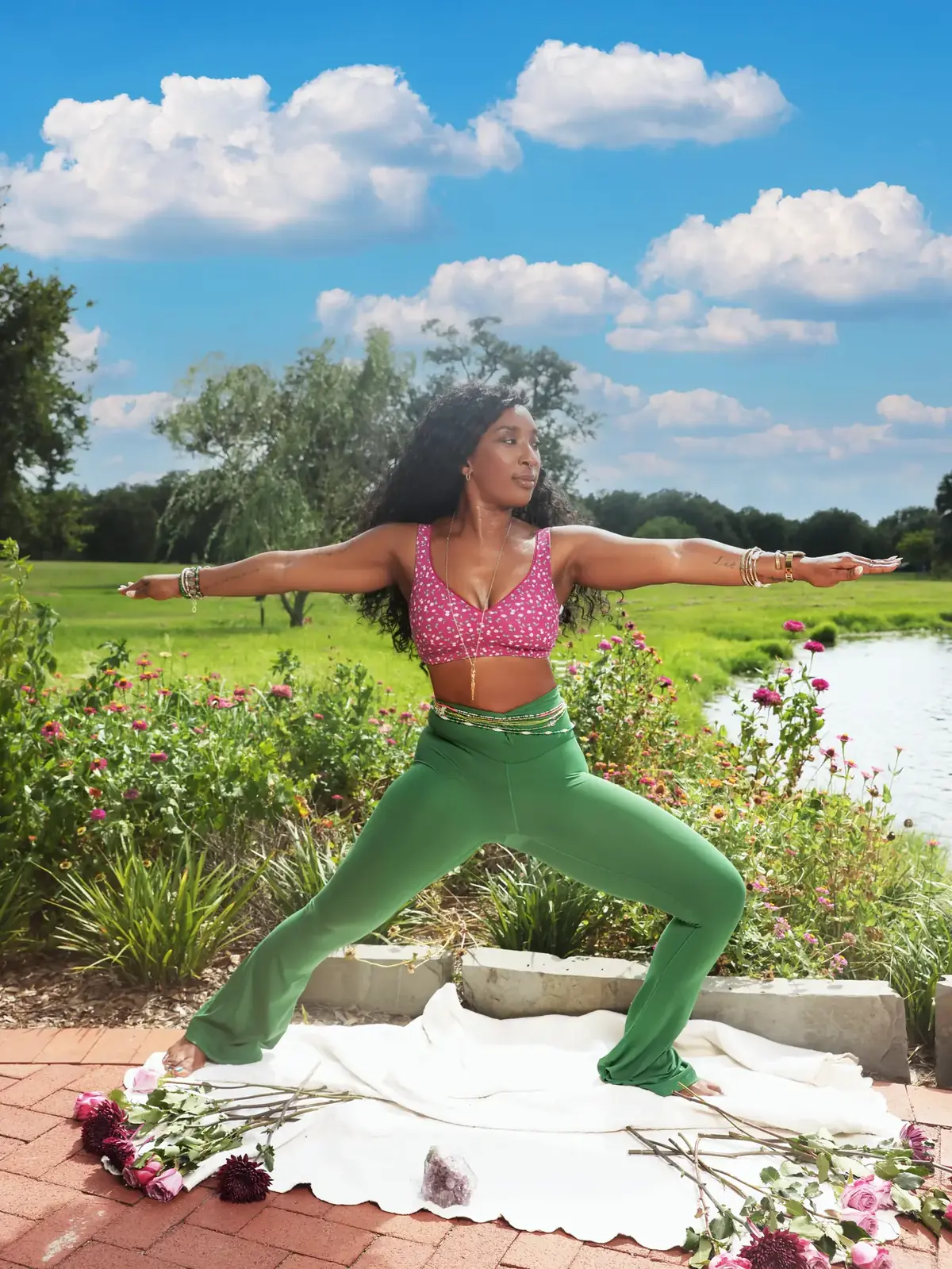 Tieara Dokes practicing a strong standing yoga pose beside the water